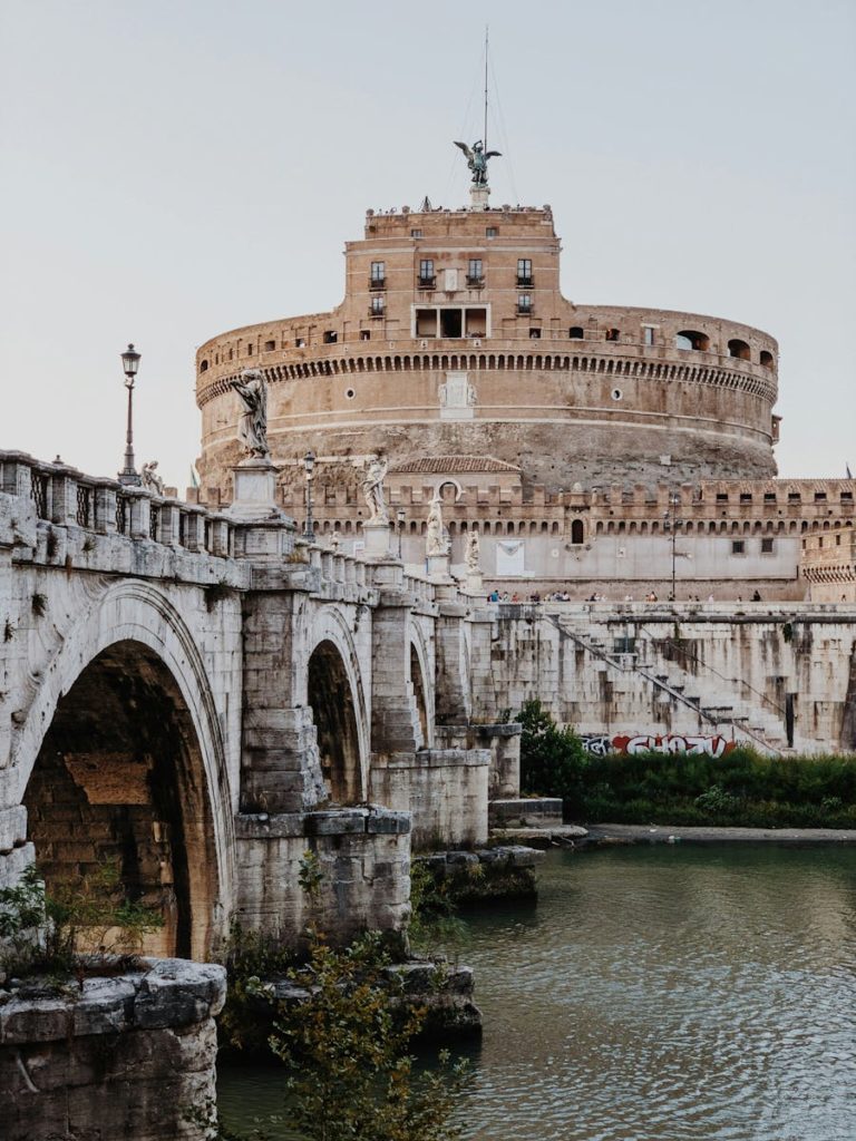 View of Castel Sant'Angelo and the St. Angelo Bridge over the Tiber River in Rome, Italy.