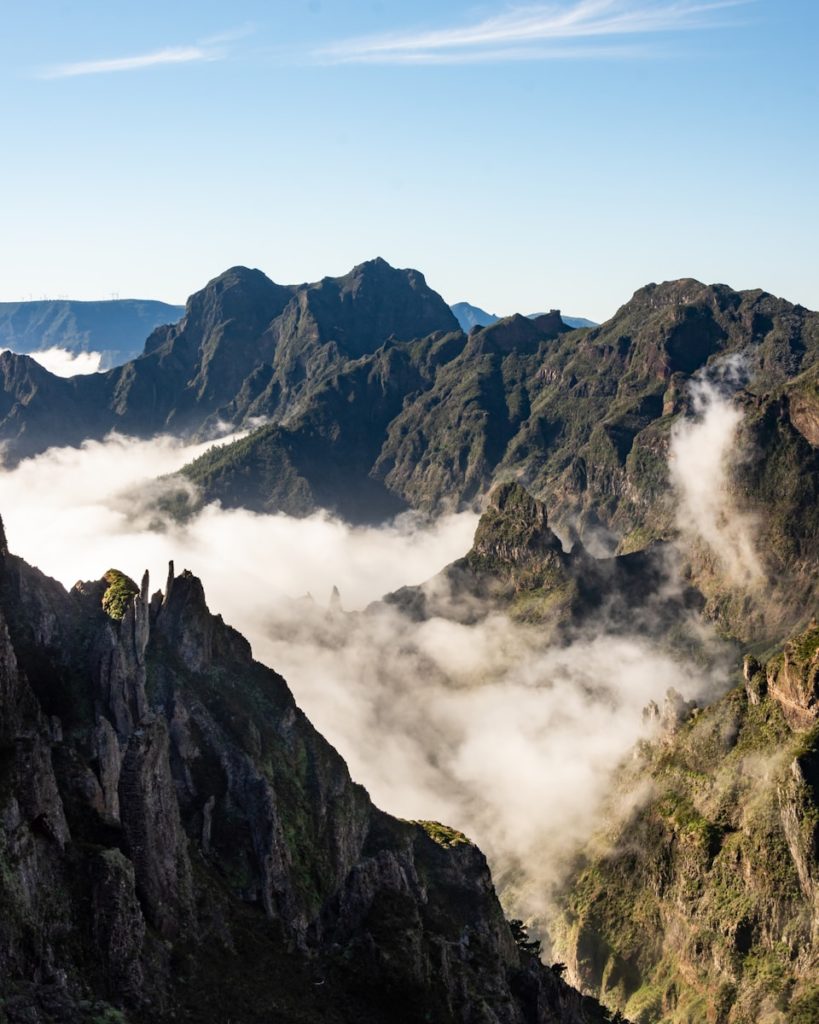 a view of a mountain range covered in clouds