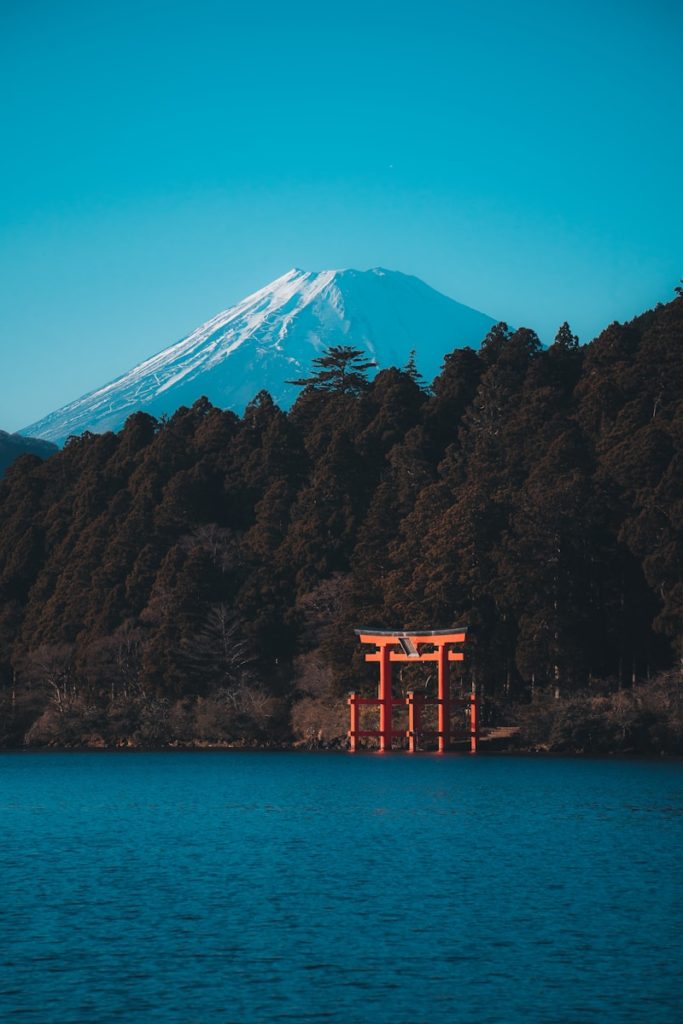 a large body of water with a mountain in the background