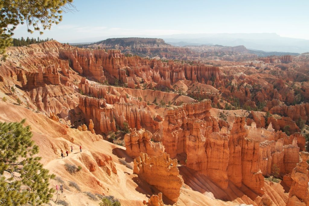 a group of people standing on top of a cliff