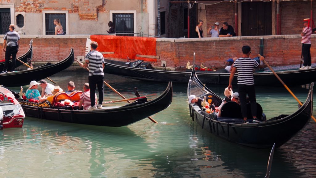 A group of people riding on top of gondolas