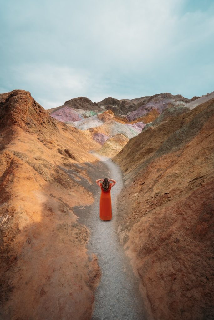 orange and white traffic cone on brown dirt road