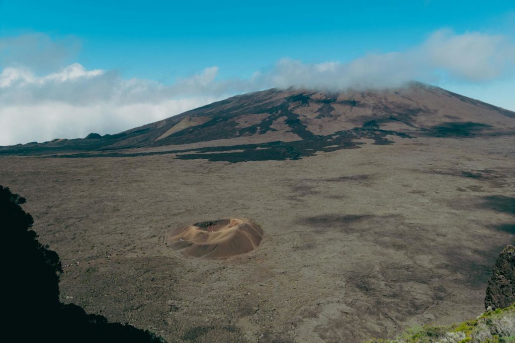A breathtaking aerial view of the Piton de la Fournaise volcano on La Réunion, showcasing its vast crater and rugged landscape.