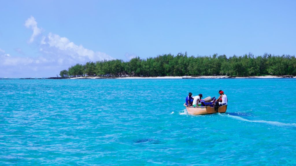 a group of people on a boat in the ocean