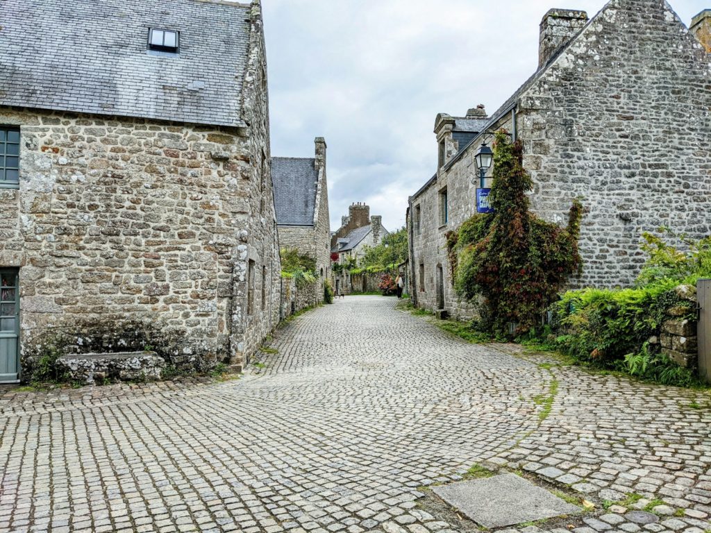 a cobblestone street lined with stone buildings