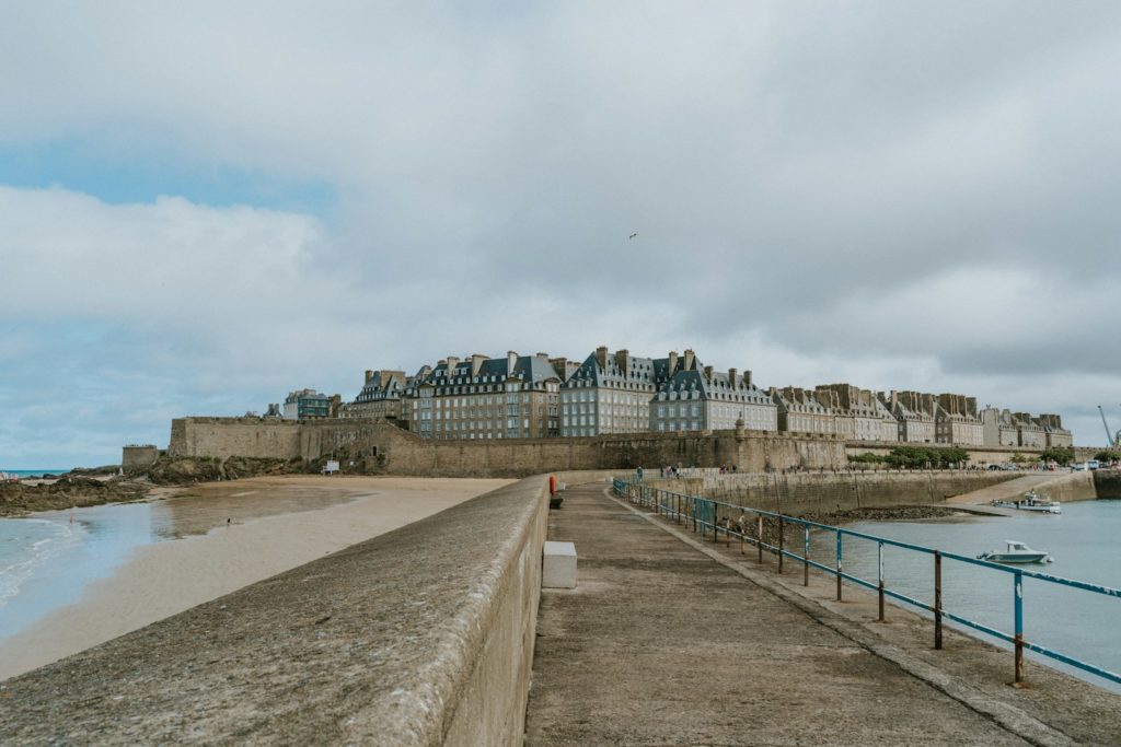 A sandy beach next to a body of water