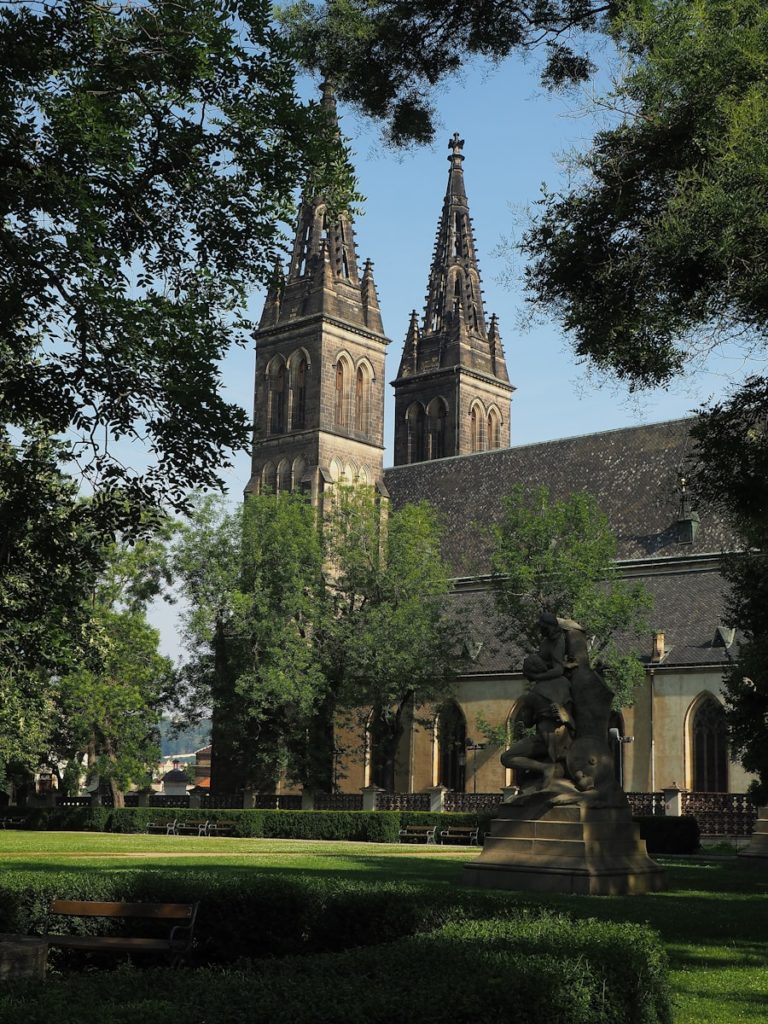 A large church with a tall steeple surrounded by trees