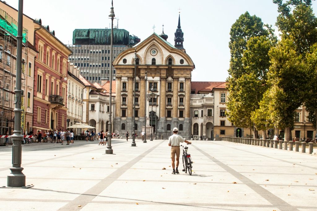 5 jours en Slovénie : itinéraire tranquille autour de Ljubljana 3 person standing beside bike in front of buildings during daytime
